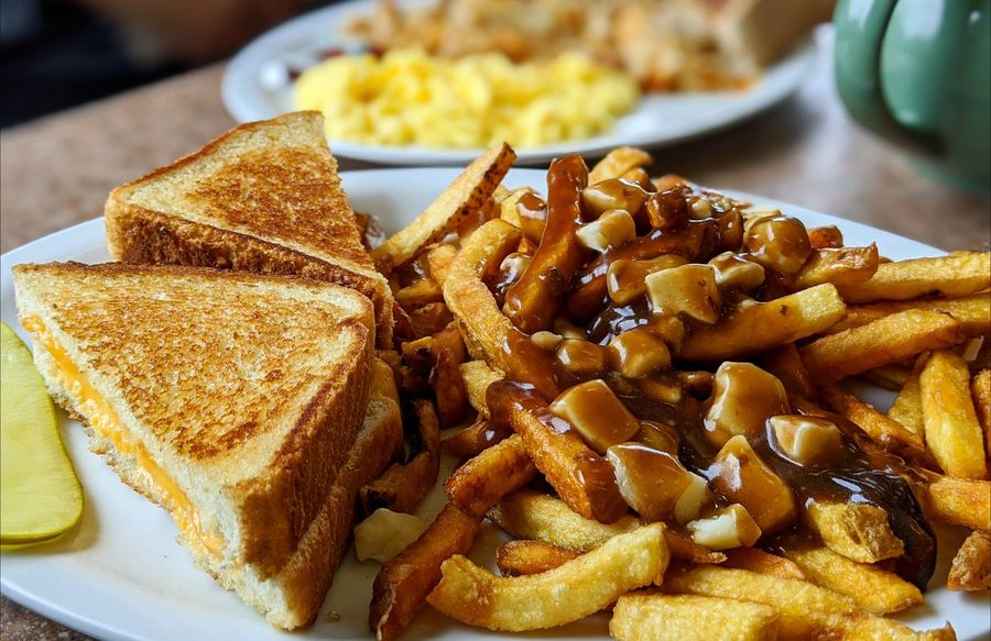 Grilled cheese with a side of poutine, fresh cut fries under gravy and curds
